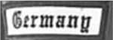 Dieses weiße Kennzeichen mit schwarzer Umrandung in Form eines Rechtecks enthält den Ländernamen „Germany“ in schwarzen Buchstaben.